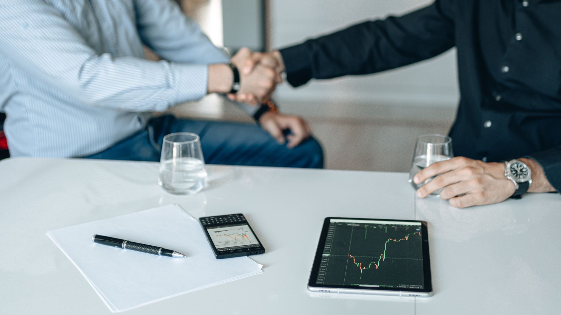 Corporate partners shaking hands reflecting strategic growth alignment